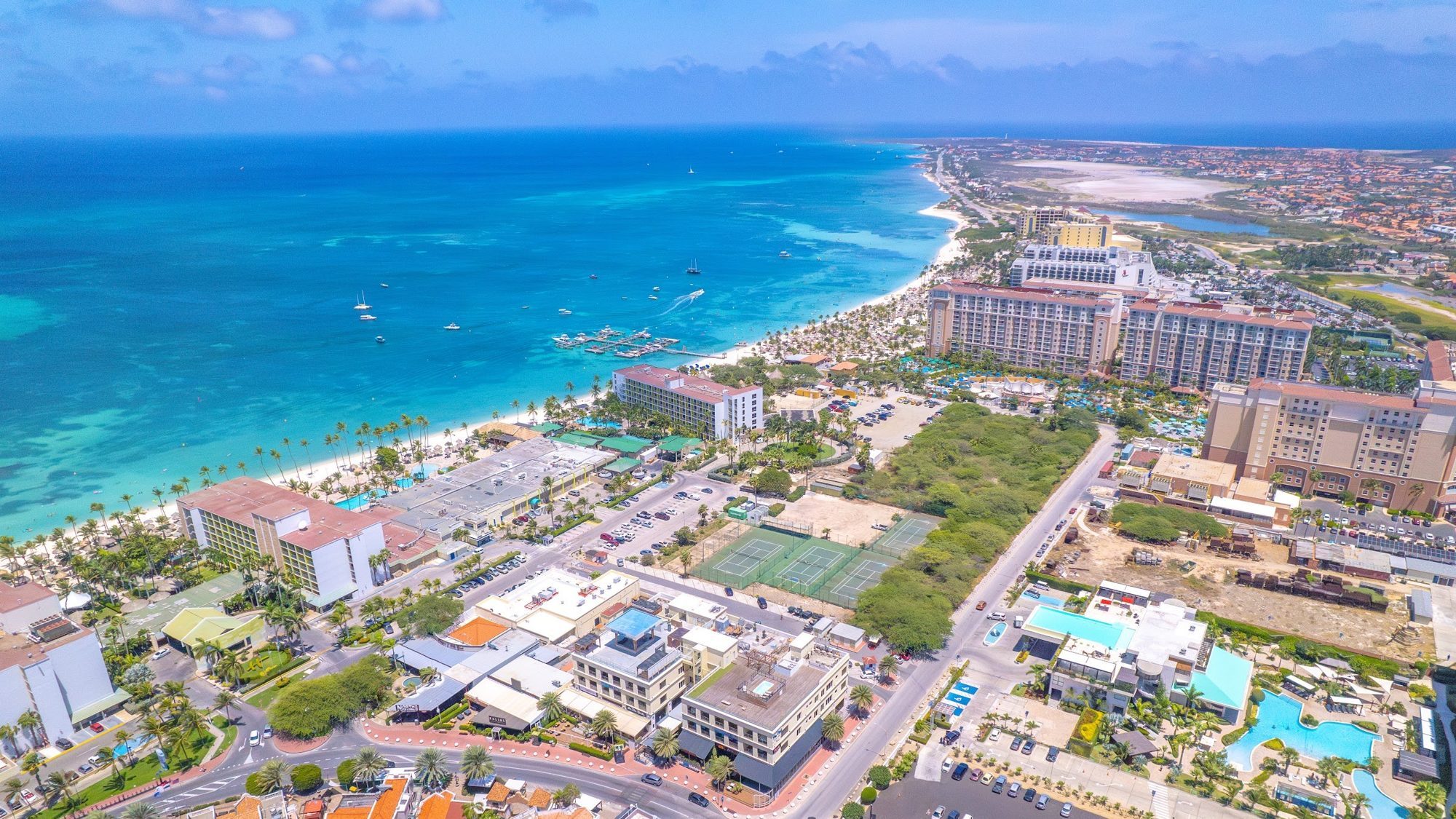 Drone view over Palm Beach with The Cove rooftop pool in the foreground